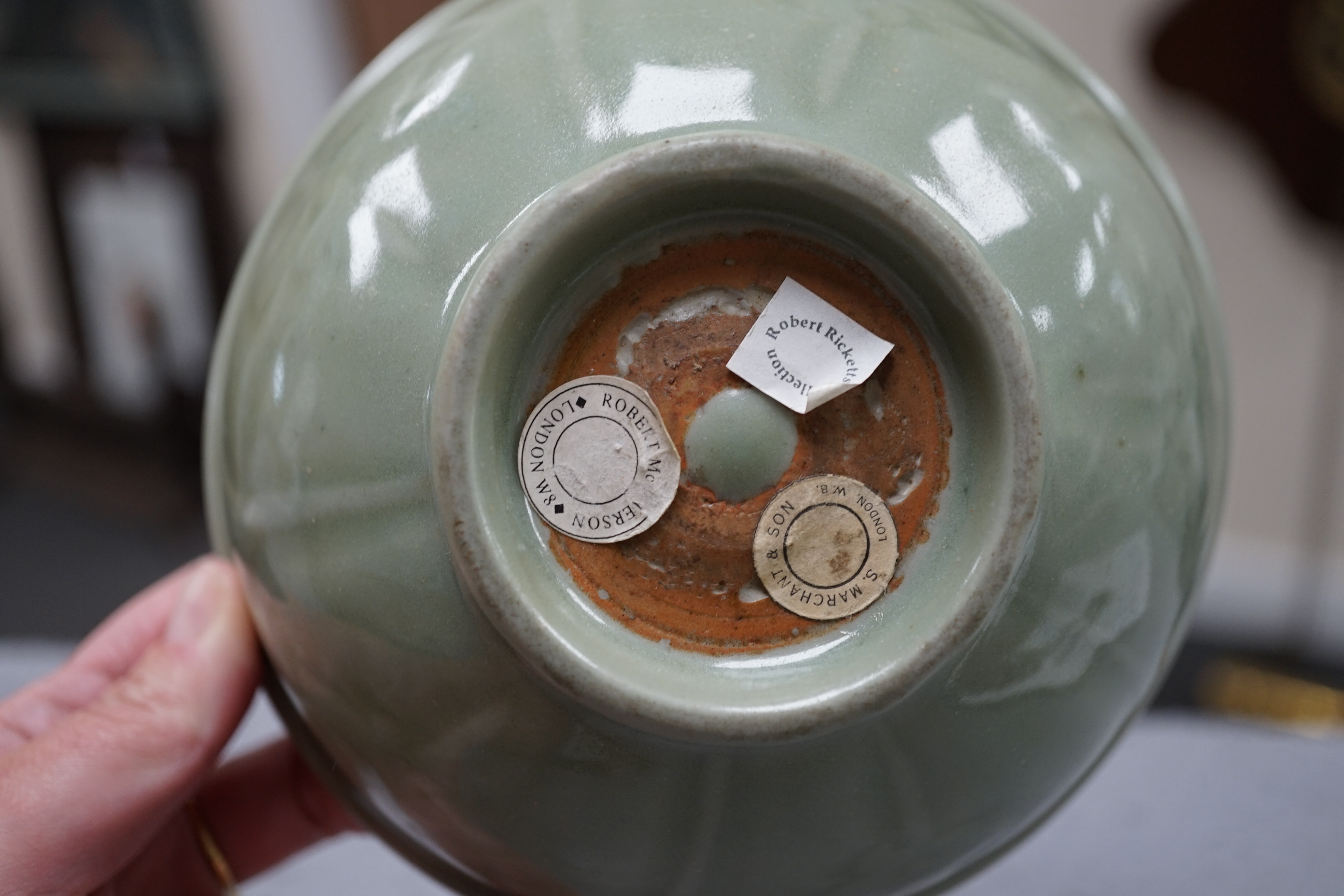 A Chinese Longquan celadon bowl, the interior carved with lotus flowers and the exterior with foliate lappets, 15.2cm diameter., Provenance - Robert Ricketts collection, formerly sold by Robert McPherson, London and S. M